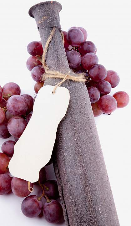 Grapes around a wine bottle Grapes around a wine bottle.