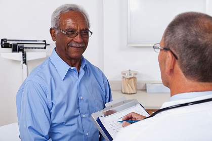 Older man talking to his doctor.