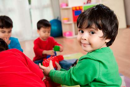 Boy playing with toy block.