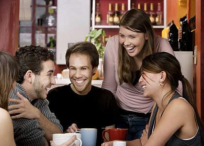 Group of people drinking coffee in a cafe.