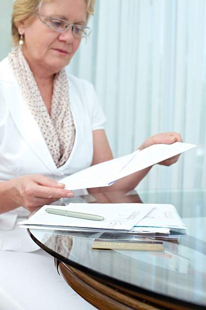 Woman looking through mail.