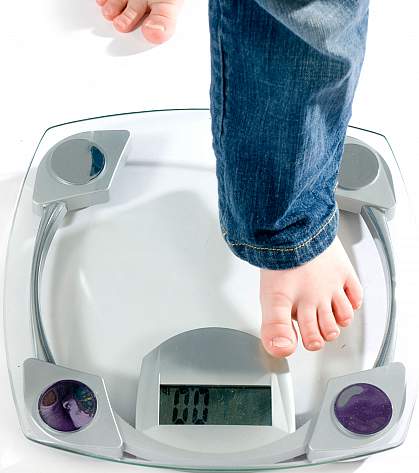 Child's foot stepping onto a scale.