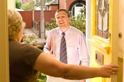 An untrustworthy man in a senior’s doorway.