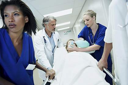 Photo of a medical team rushing a sick patient to the emergency ward. Photo of a medical team rushing a sick patient to the emergency ward.