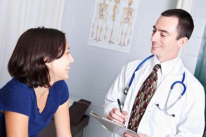 Photo of a teenage girl talking to a doctor. Photo of a teenage girl talking to a doctor.