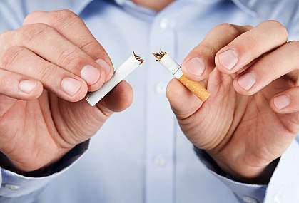 Photo of a person breaking a cigarette. Photo of a person breaking a cigarette.