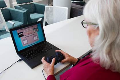 Older woman playing a computer game Older woman playing a computer game