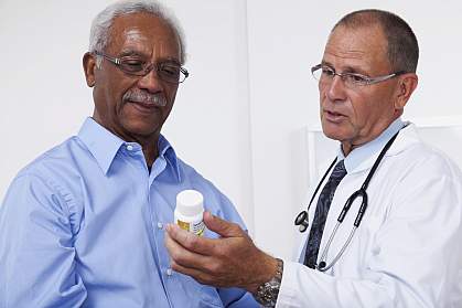 Doctor showing patient prescription bottle Doctor showing patient prescription bottle.