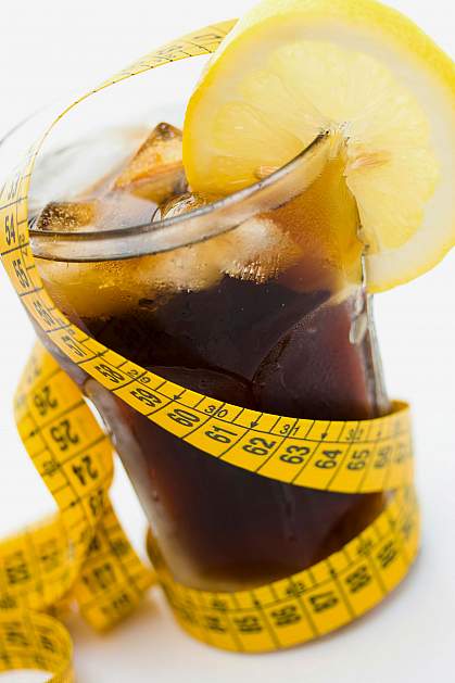 Glass of soda with a measuring tape wrapped around it Glass of soda with a measuring tape wrapped around it.