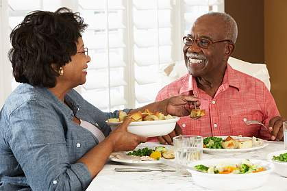 Senior couple enjoying a meal at home.