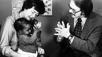 Caregivers clapping with baby Caregivers clapping with baby.