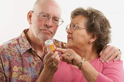 Senior couple reading a prescription bottle Senior couple reading a prescription bottle.