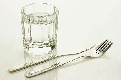 Knife and fork with a glass of water Knife and fork with a glass of water.