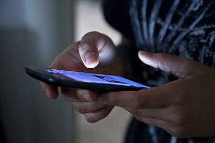Person using a smartphone Person using a smartphone