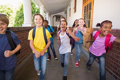 Young students running down a hall Young students running down a hall