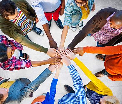 Circle of diverse people joining hands in the center Circle of diverse people joining hands in the center.