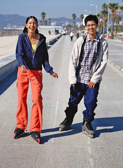 Teenage boy and girl on inline skates.