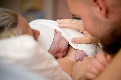 Happy couple with newborn baby.