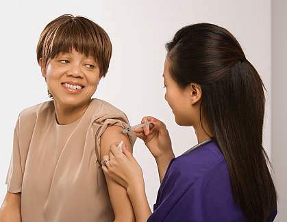 Patient receiving flu vaccine. Patient receiving flu vaccine.