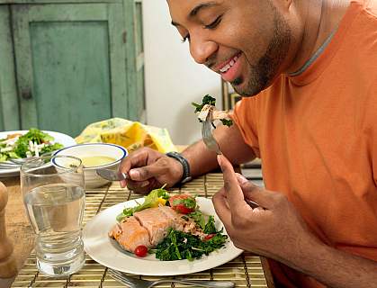 Man happily eating a salmon salad Man happily eating a salmon salad
