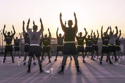 Soldiers stretch during sunrise before an early morning run Soldiers stretch during sunrise before an early morning run