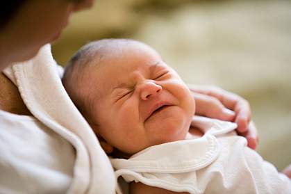A mother holding her sleeping baby A mother holding her sleeping baby.