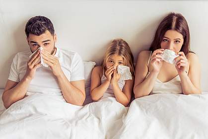 Family in bed together with colds Family in bed together with colds