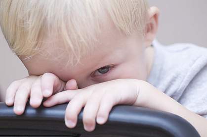 Blonde toddler peeking over a chair Blonde toddler peeking over a chair