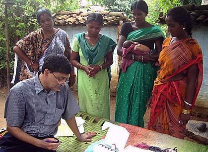 Doctor with four women, one holding a baby Doctor with four women, one holding a baby