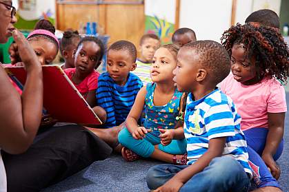 Teacher reading a book with a class of preschool children Teacher reading a book with a class of preschool children