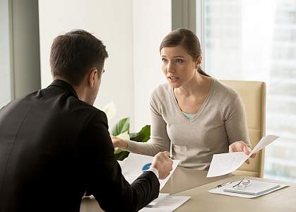 Stressed woman arguing with colleague at work Stressed woman arguing with colleague at work