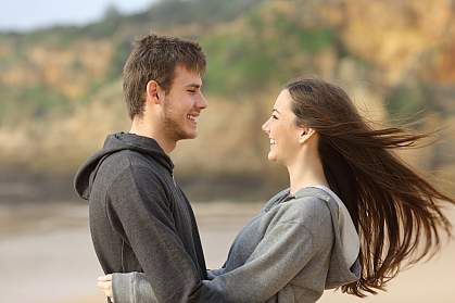 Happy teen couple gazing into each other’s eyes. Happy teen couple gazing into each other’s eyes.
