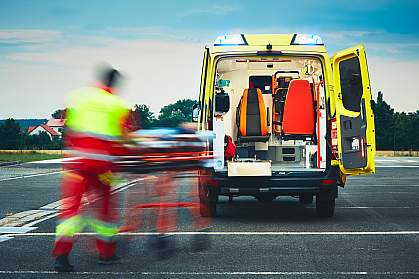 Emergency medical service team rushing someone to an ambulance Emergency medical service team rushing someone to an ambulance