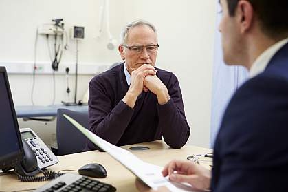 Doctor discussing test results with concerned patient Doctor discussing test results with concerned patient