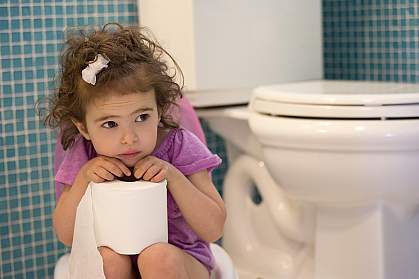 Young girl on children’s toilet Young girl on children’s toilet.