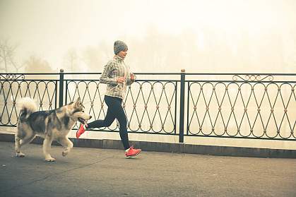 Woman jogging with a dog Woman jogging with a dog.