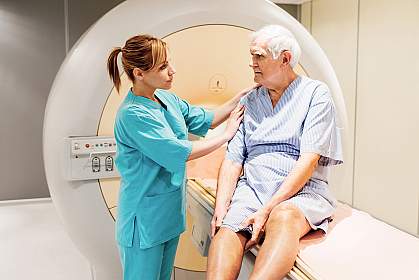 Female nurse preparing a mature patient for an MRI Scan Female nurse preparing a mature patient for an MRI Scan.