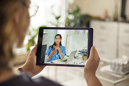 Patient talking to a doctor using a digital tablet Patient talking to a doctor using a digital tablet