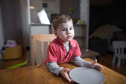 Young boy with empty plate Young boy with empty plate