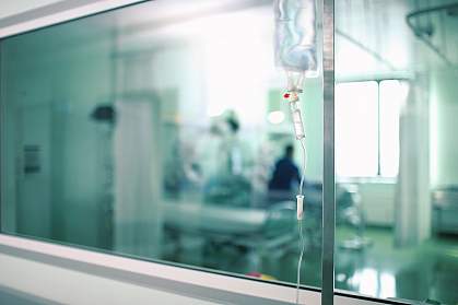 Blurred photo of a hospital room through a corridor window Blurred photo of a hospital room through a corridor window