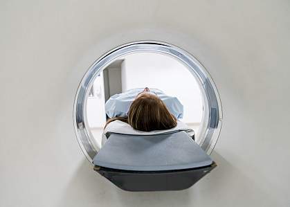 Female patient lying down for an MRI exam Female patient lying down for an MRI exam