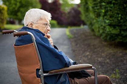 Senior man man sitting in a wheelchair outside. Senior man man sitting in a wheelchair outside.