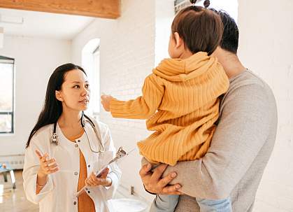 Father and toddler consulting with doctor Father and toddler consulting with doctor