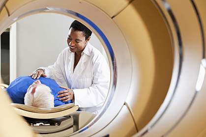 Radiologist preparing patient for PET imaging scan Radiologist preparing patient for PET imaging scan