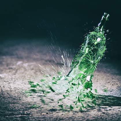 Green wine bottle hitting the floor and breaking