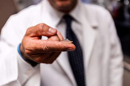 Researcher holding microneedle array on fingertip Researcher holding microneedle array on fingertip