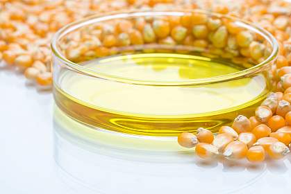 Corn kernels with a dish of high fructose corn syrup Corn kernels with a dish of high fructose corn syrup