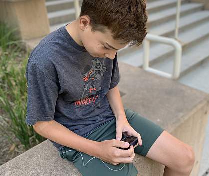 Study participant reviews information on his artificial pancreas device. Study participant reviews information on his artificial pancreas device.