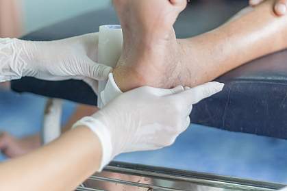 Doctor bandaging a foot wound Doctor bandaging a foot wound