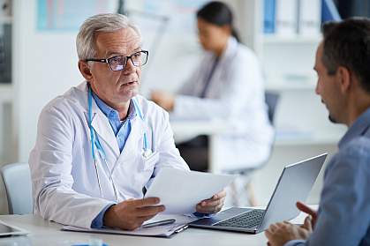 Doctor talking to mature male patient Doctor talking to mature male patient